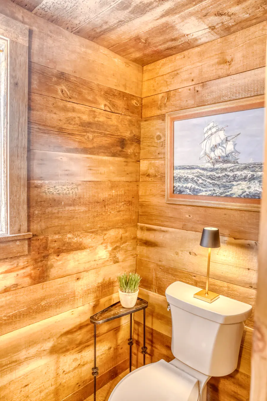 Powder room paneled in reclaimed barn wood