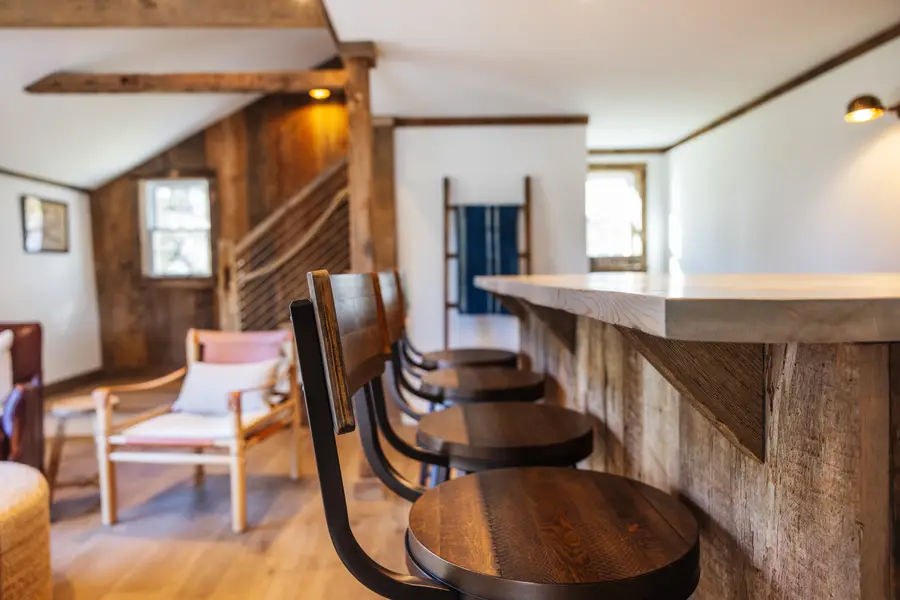 Bar stools along the reclaimed wood bar