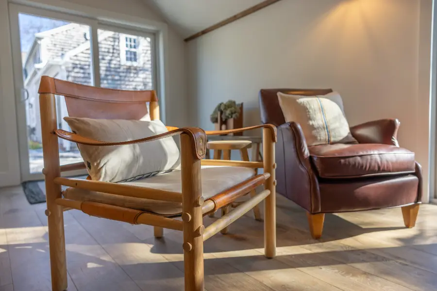 Leather and wood armchairs by the window