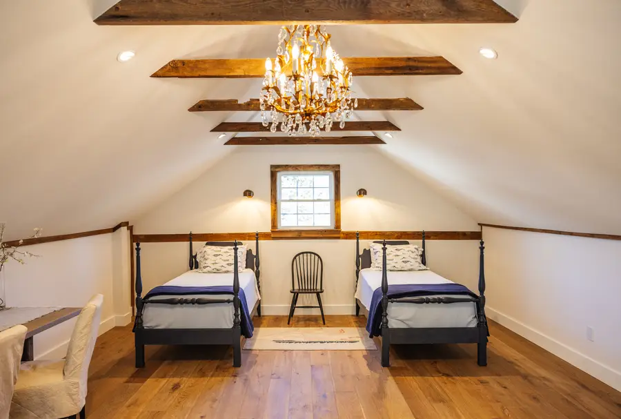Loft bedroom with twin beds under the old beams