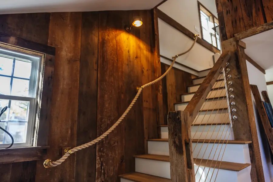 Staircase with rope rail and barn board walls