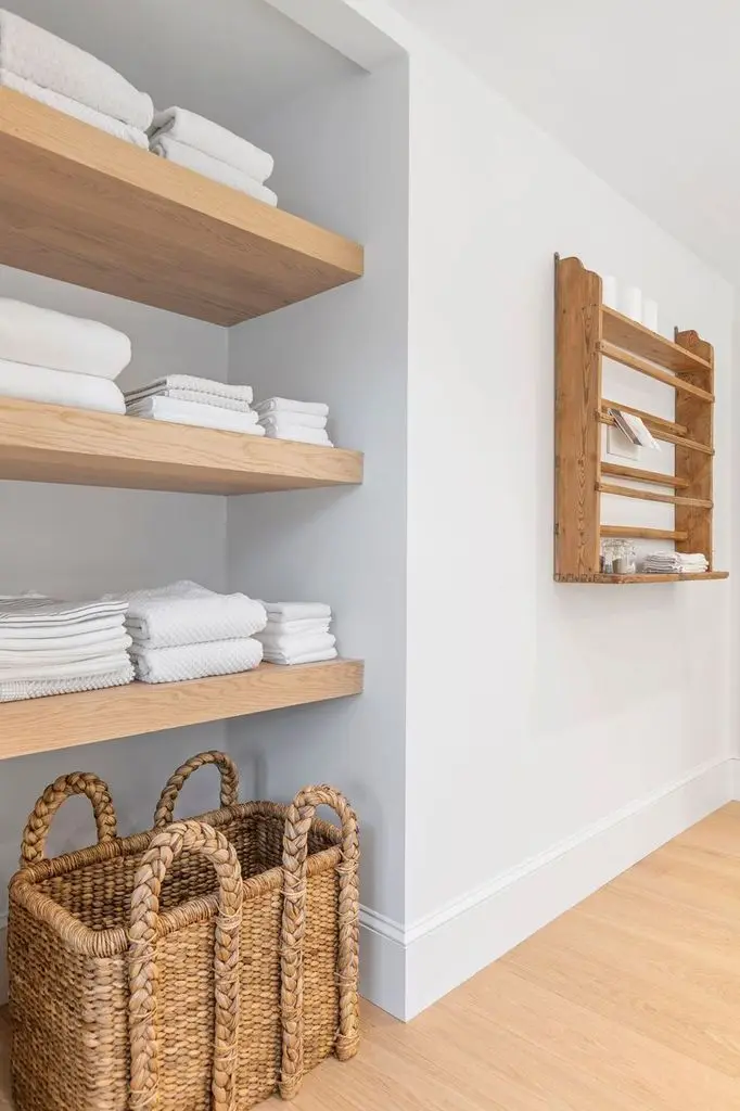 Floating oak shelves with towels and baskets