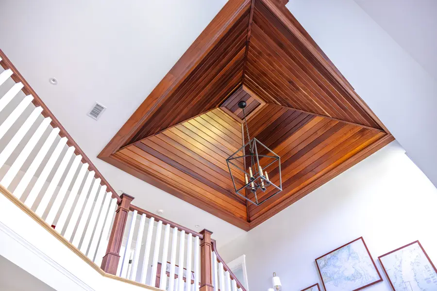 Cedar coffered ceiling above a staircase with a lantern
