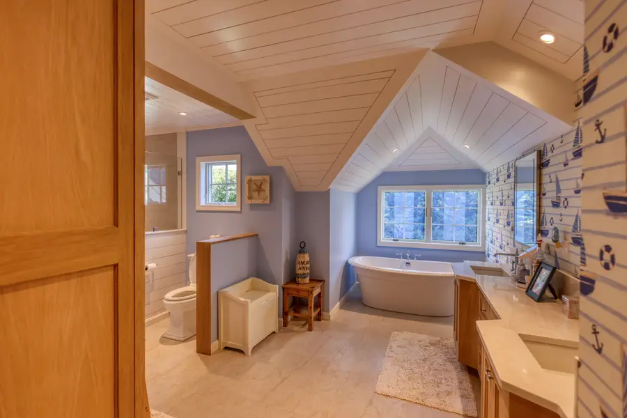 Bathroom through the door, tub under the window