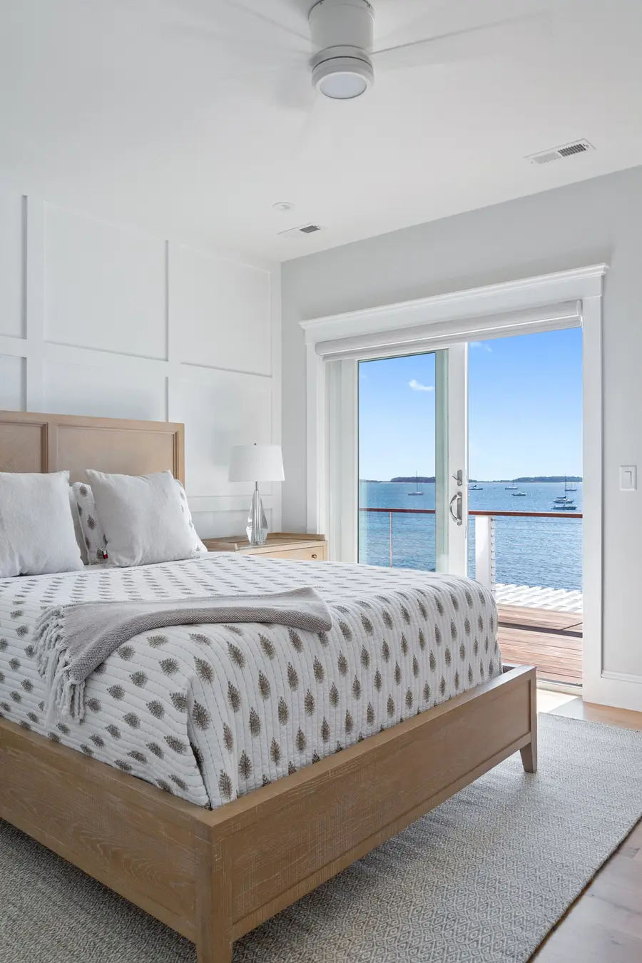 Bedroom with French doors opening to the water