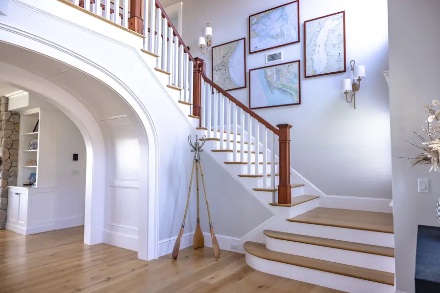 Main entry with the curved staircase under an arched opening