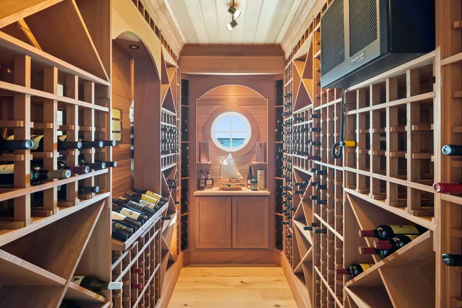 Wine room with wood racks and a porthole window