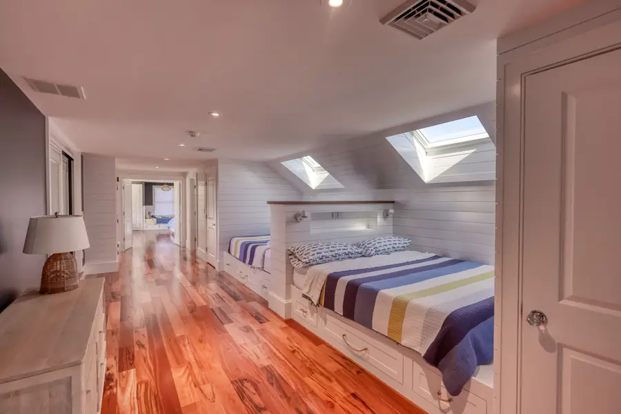 Bunk room with built-in beds under the skylights
