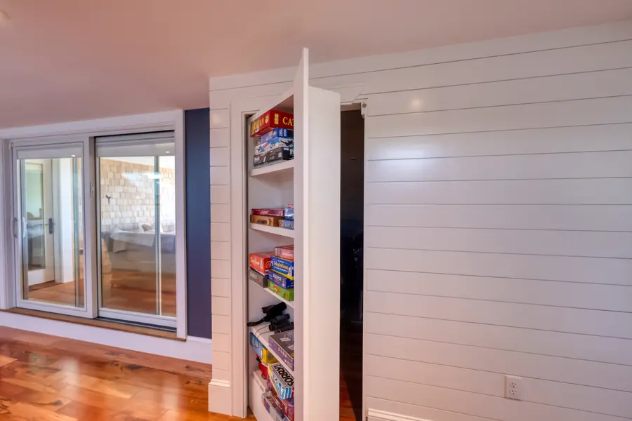 Built-in bookshelf beside shiplap walls