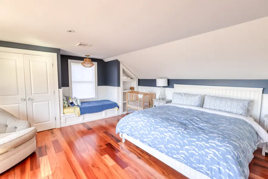 Bedroom with a daybed and wood floors