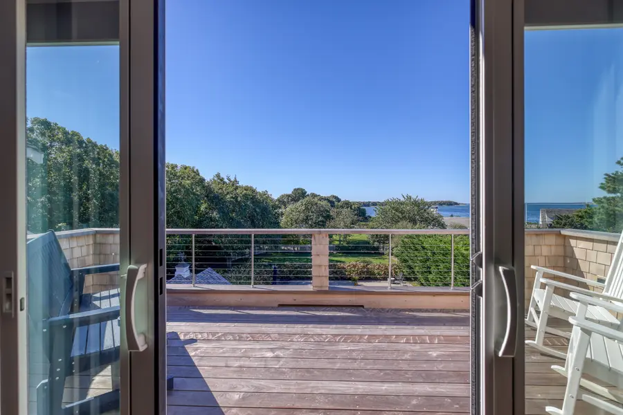 Sliding doors open to the deck and the water