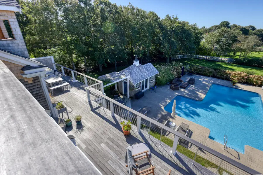 Deck stairs down to the pool and pool house