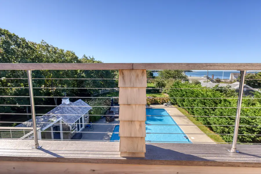 Deck rail framing the pool and the water