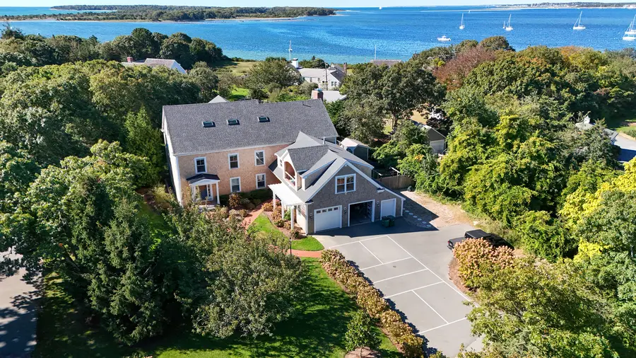 The house among the trees with the harbor behind it