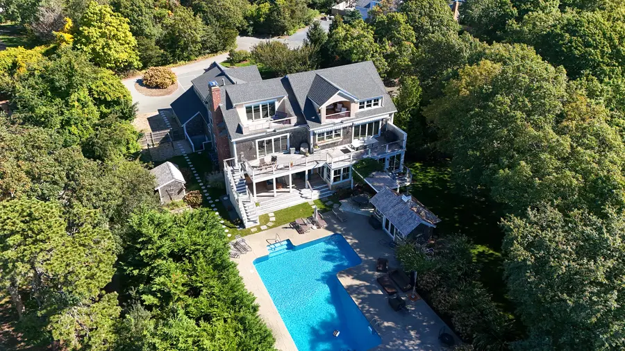 Pool and house seen from above the trees