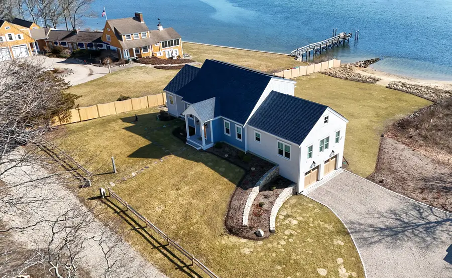 Aerial view of the new home on the Bass River, lawn running down to the beach