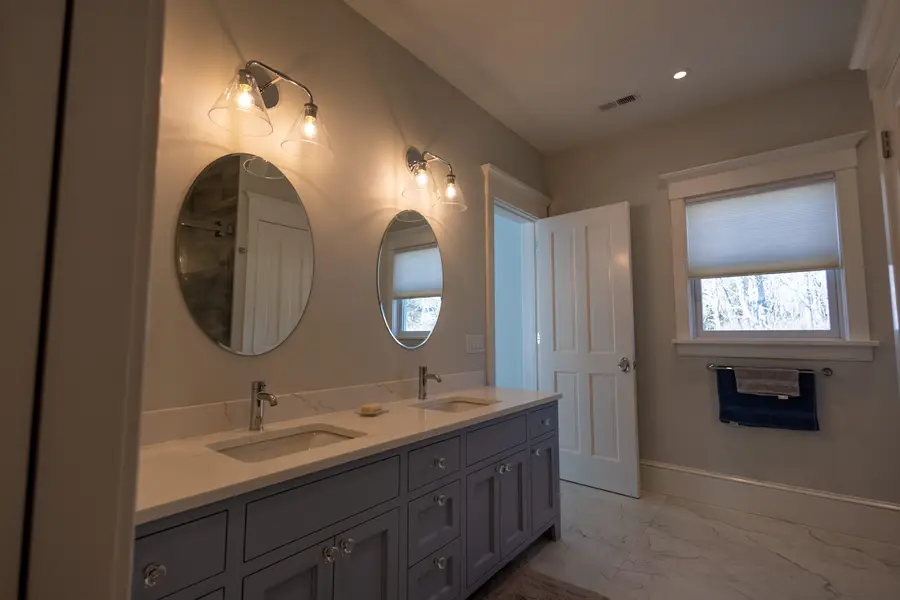 Bathroom with a double vanity and round mirrors