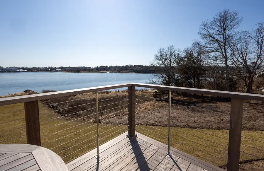 Deck with a cable railing looking out over the Bass River