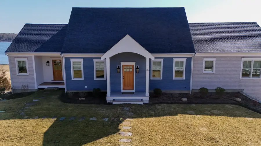 Front of the new home with a gabled entry and a wood front door