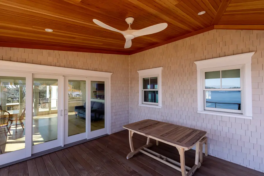Screened porch with a tongue-and-groove cedar ceiling and a ceiling fan
