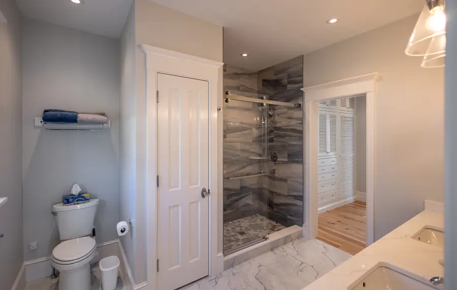 Bathroom with a tiled walk-in shower and glass door