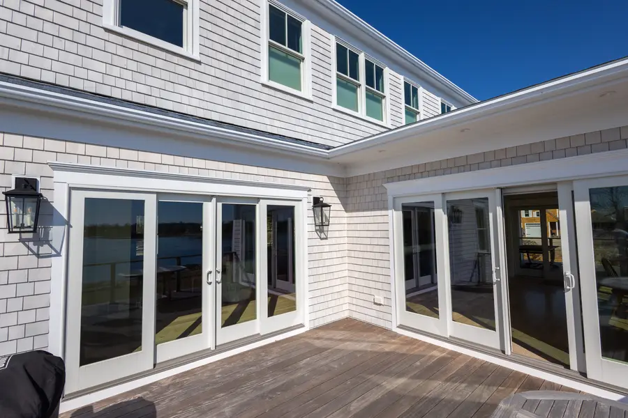 Rear deck with sliding doors on two sides of the house