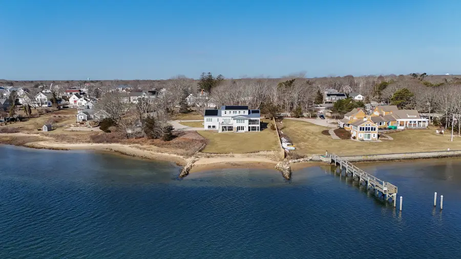 The home seen from across the Bass River, with the dock and beach below