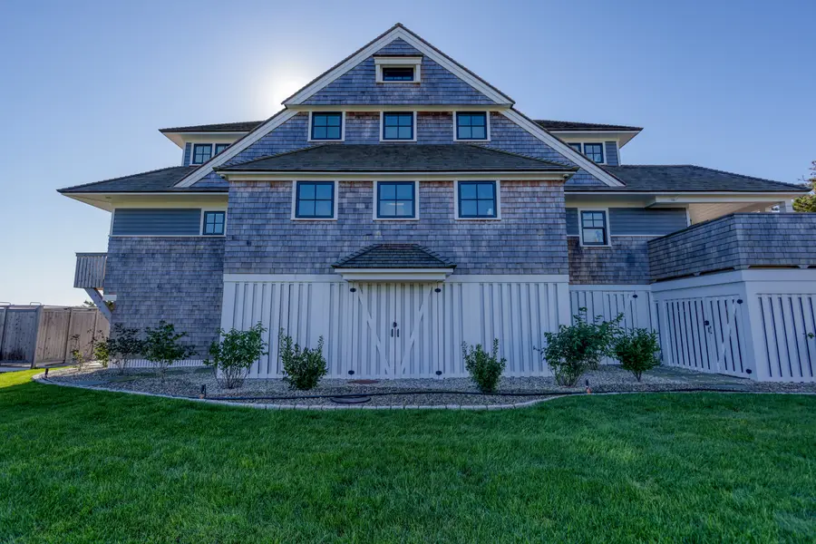 Front of the house with its cedar roof and white trim