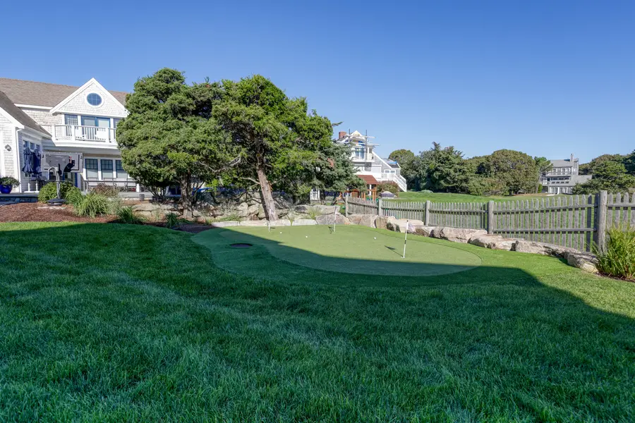 Putting green with the neighborhood beyond
