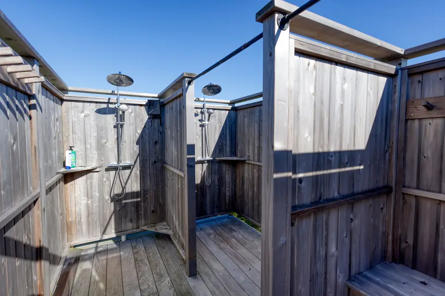 Outdoor shower with its bench and fixtures