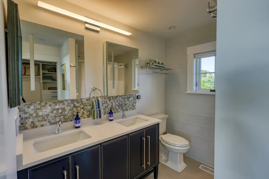 Bathroom vanity with a mosaic backsplash