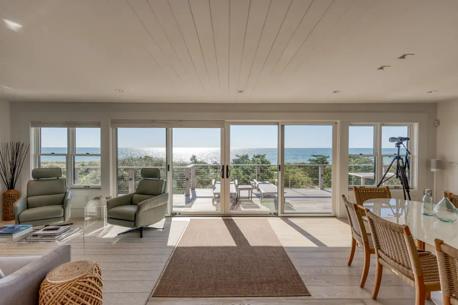 Open living and dining room facing the water