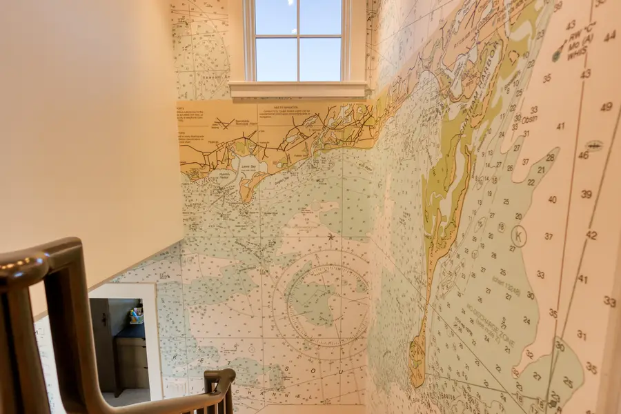 Stair wall papered with a nautical chart