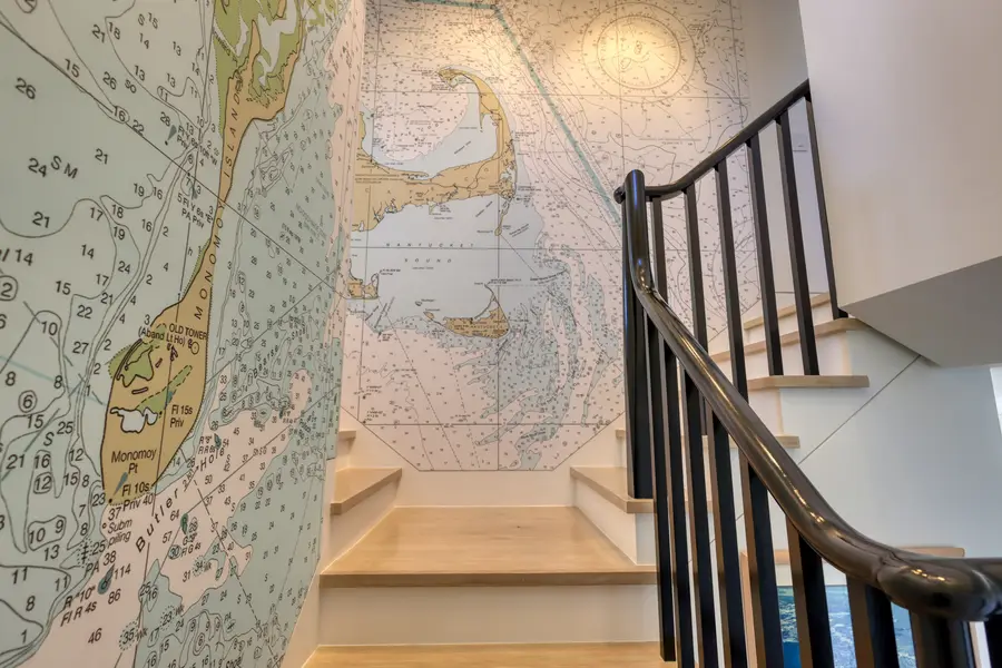 Staircase beside a nautical chart mural
